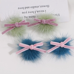 Detailed view of handmade velvet ribbon bows and plush balls for DIY hair accessories