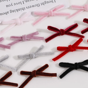 Macro shot of assorted handmade velvet bow accessories for jewelry and hair clip DIY making