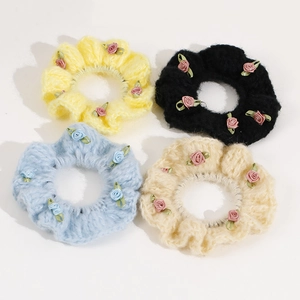 Set of four knit flower scrunchies with handmade ribbon roses and crochet texture