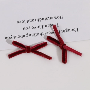 Detail of burgundy velvet handmade bows for DIY hair clips and jewelry accessories