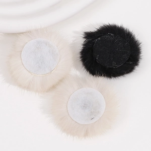 Macro detail of plush faux fur round patches with non-woven backing for DIY accessories