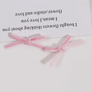 Detailed view of handmade pink velvet ribbon bows for DIY hair accessories and earrings