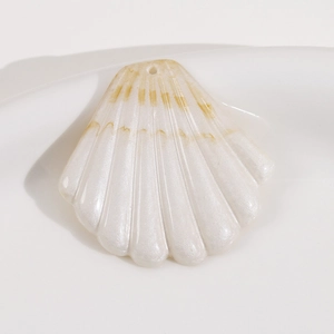 Vue détaillée d'un pendentif coquillage en résine crème avec finition nacrée et trou de DIY
