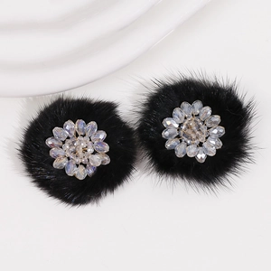 Close-up of plush black flower hair accessories with crystal beaded flower centers