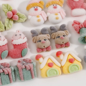 Macro detail of flocked Christmas resin charms with snowman and reindeer textures