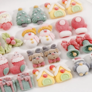 Close-up of soft flocked Christmas resin charms including reindeer, trees and snowmen for DIY crafts