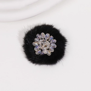 Detailed view of handmade black fur flower patch with sparkling crystal beaded center