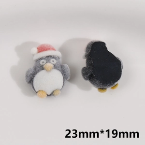 Detailed macro view showing 23mm flocking penguin charms for DIY Christmas accessories