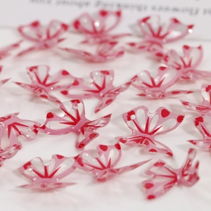 Macro detail of pink semi-transparent butterfly resin charms for DIY jewelry making
