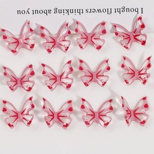 Set of 12 translucent pink resin butterfly pendants with red heart patterns for DIY crafts