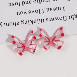 Detailed view of pink translucent butterfly resin charms for DIY jewelry making