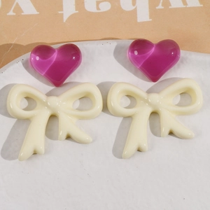 Purple heart beads and cream resin bow charms set for DIY jewelry making and crafting