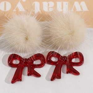 DIY accessory set featuring cream faux fur pom poms and dark red resin bows for jewelry