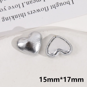 Macro detail of 15mm silver heart-shaped alloy jewelry accessories with foil texture