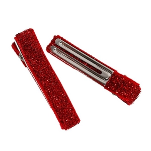 Lot de deux barrettes rouges à paillettes avec clips crocodiles en métal sur fond blanc