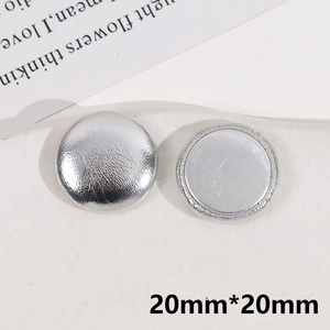 Macro shot of a 20mm round silver textured button with flat metal base for DIY jewelry
