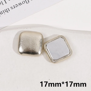 Detail view of 17mm square champagne gold faux leather buttons with silver backing