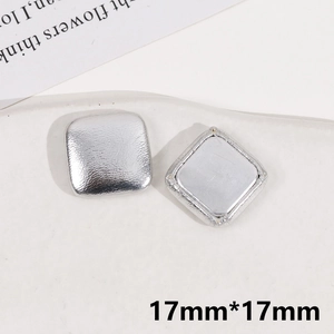 Close-up of silver square fabric buttons 17mm x 17mm for DIY jewelry making and crafts