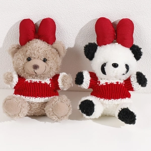 Detail of plush bear and panda toys wearing red bow ties and festive knit sweaters