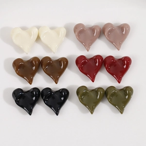 Flat lay of colorful glossy resin heart DIY charms in diverse organic shapes and rich tones