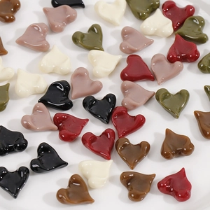 Close-up of heart-shaped resin charms with irregular surfaces for DIY jewelry crafts
