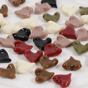 Close-up of colorful heart-shaped glossy resin charms for DIY jewelry making