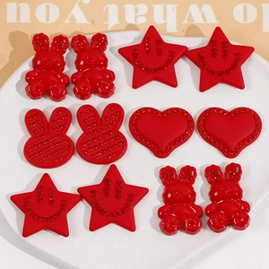 Detail of red acrylic charms including bunnies stars and hearts with rhinestone accents