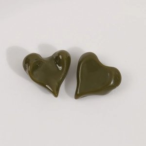 Detail view of glossy olive green resin heart charms for DIY jewelry accessories