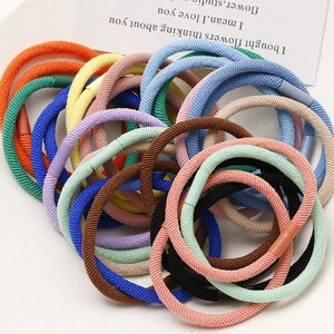 Macro shot of multi-color elastic hair ties with woven texture and reinforced joints