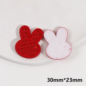 Macro view of 30x23mm red rabbit acrylic charm with sparkly rhinestones for DIY crafts