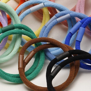 Detailed view of high-elasticity braided hair ties in various colors with secure joints