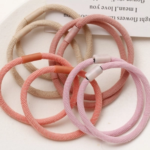Detail of high-elasticity ribbed hair ties in Morandi colors with matte plastic joints
