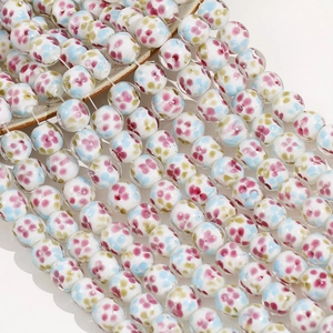 Close-up of 14mm floral lampwork glass beads for DIY jewelry making and crafts