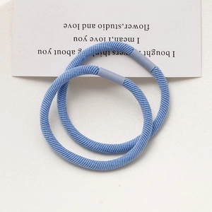 Detail of light blue high-elastic hair ties with ribbed texture and matte connectors