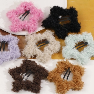 Detailed view of colorful plush star hair clips set in seven vibrant pastel shades