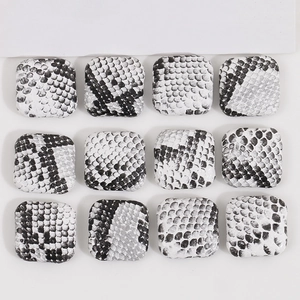 Macro view of square 12pcs DIY buttons with black and white snakeskin leather texture