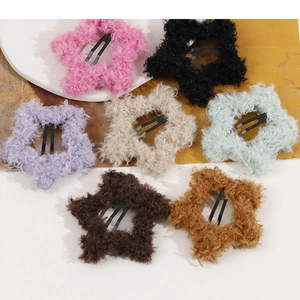 Detail of seven colorful plush star hair clips with soft texture and metal BB clip base