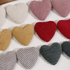 Macro detail of plush corduroy heart patches with metallic threads for DIY hair accessories