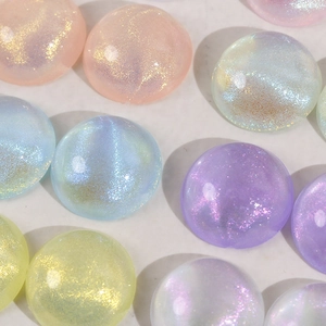 Macro shot of colorful glittery acrylic dome beads for DIY jewelry and accessories