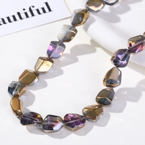 Close-up of irregular multifaceted AB gradient glass beads with golden purple metallic finish