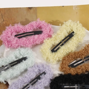 Detail showing plush teddy fleece texture and vibrant colors on colorful hair clips set