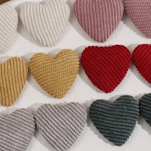 Detail of heart-shaped corduroy fabric patches with metallic thread for DIY crafts
