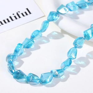 Macro shot of iridescent blue irregular faceted glass beads for DIY jewelry making