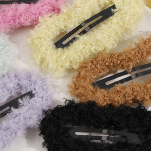 Close-up of colorful plush faux fur BB hair clips in pink, yellow and lavender purple
