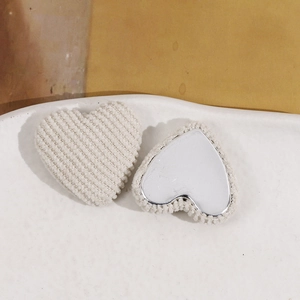 Detail of plush beige corduroy and silver mirror heart-shaped DIY accessories