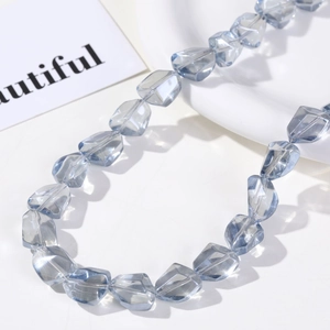 Detail of light blue irregular faceted glass beads for DIY jewelry making and crafts