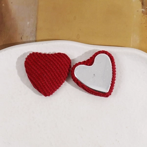 Detailed view of red plush heart DIY charms showing corduroy texture and flat metal back