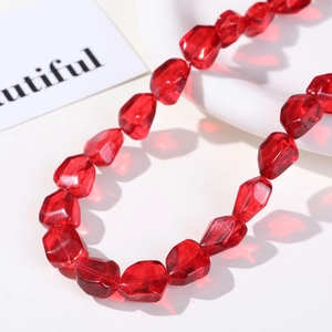 Macro detail of red faceted irregular glass beads for DIY jewelry making and crafts