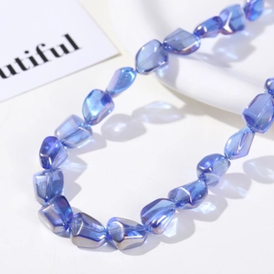 Macro shot of iridescent blue faceted glass beads with metallic coating for DIY jewelry