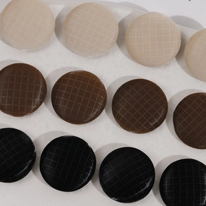 Detailed macro view of 17mm round fabric buttons with white grid pattern in three colors